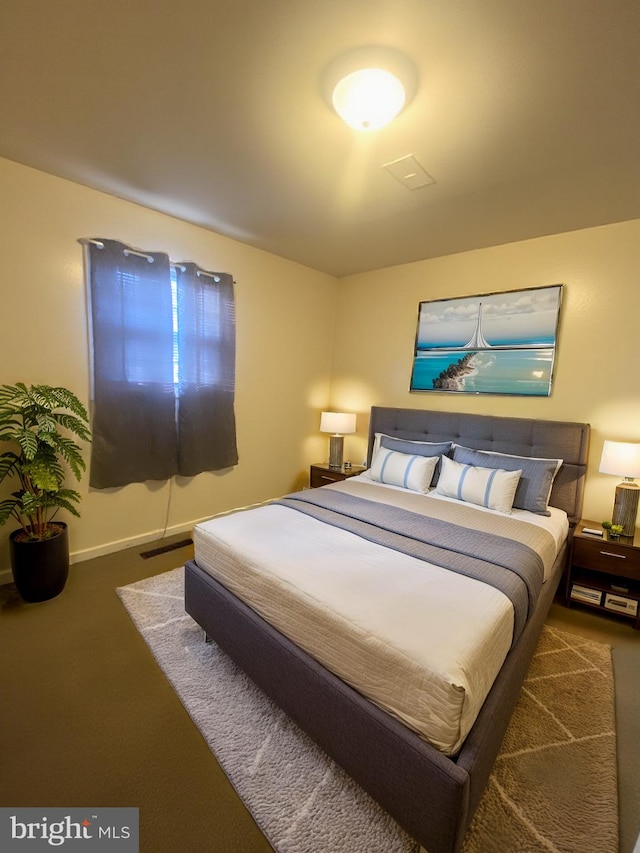 bedroom featuring baseboards and visible vents