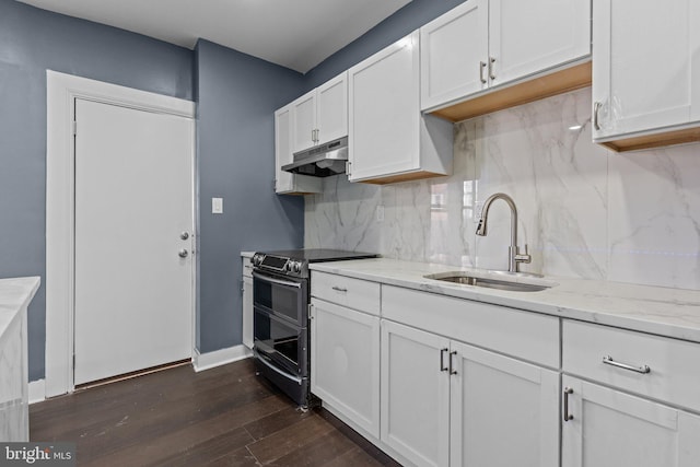 kitchen featuring double oven range, dark wood-style flooring, a sink, white cabinets, and under cabinet range hood