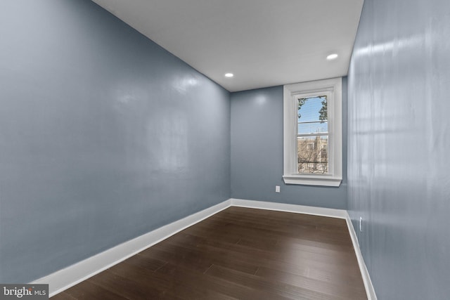 unfurnished room featuring recessed lighting, baseboards, and dark wood-style flooring