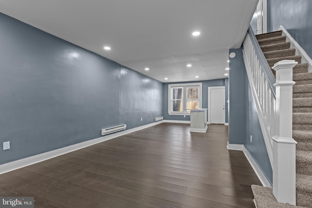 unfurnished living room featuring a baseboard heating unit, dark wood-style floors, recessed lighting, stairway, and baseboards