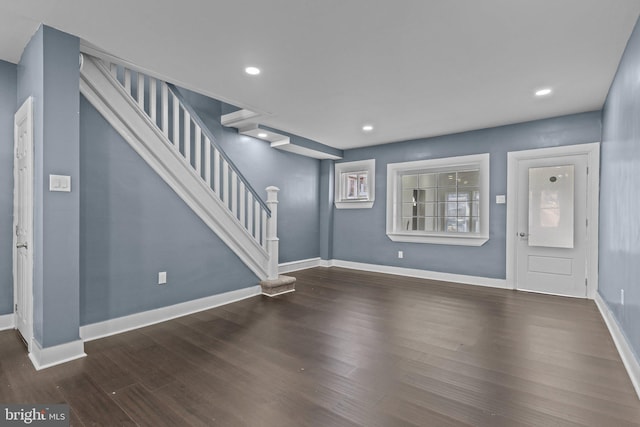 entrance foyer featuring stairs, baseboards, and wood finished floors