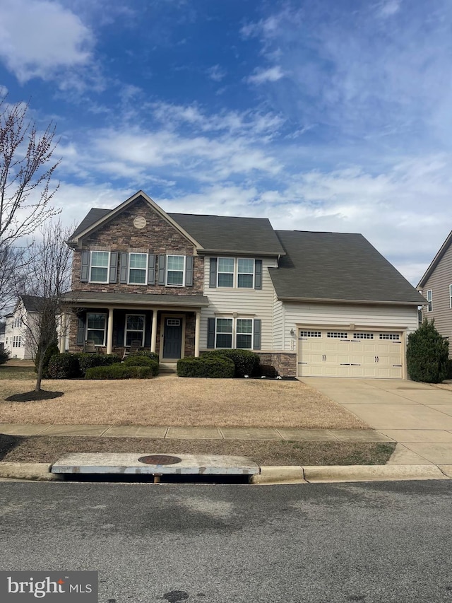 3525 Silent Creek Rd, White Plains, MD 20695 - view of front facade with concrete driveway, stone siding, a garage, and covered porch