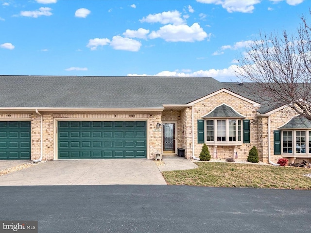 view of front of property featuring brick siding, an attached garage, concrete driveway, and roof with shingles