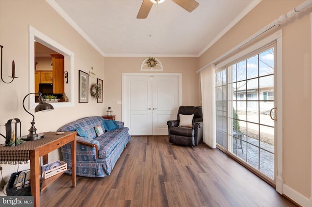 living area with a ceiling fan, crown molding, and wood finished floors