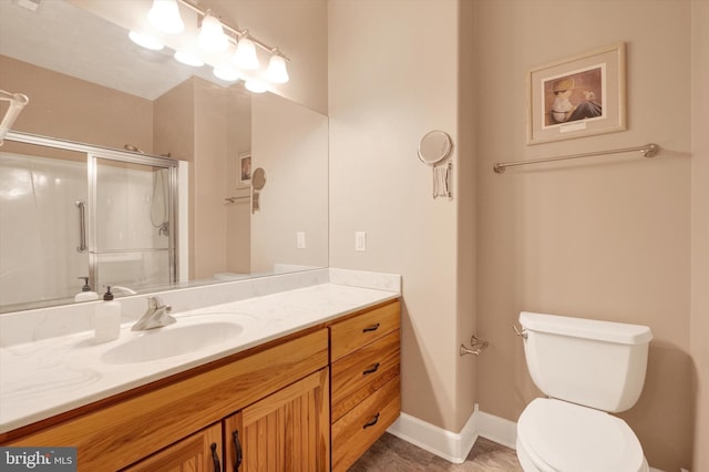 full bath featuring baseboards, toilet, a stall shower, tile patterned floors, and vanity