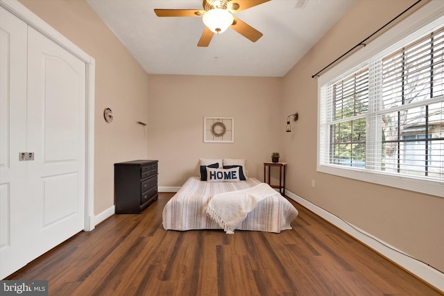 bedroom with ceiling fan, baseboards, and wood finished floors