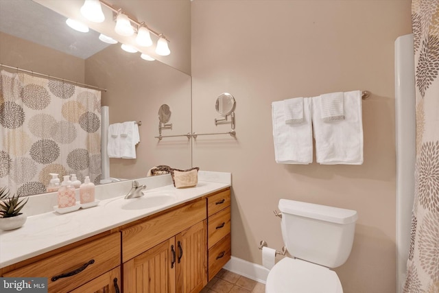 full bath with tile patterned flooring, toilet, vanity, and baseboards