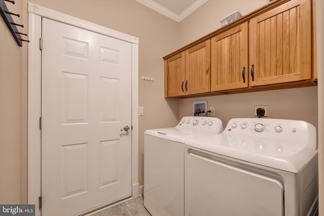 washroom with crown molding, light tile patterned flooring, cabinet space, and independent washer and dryer