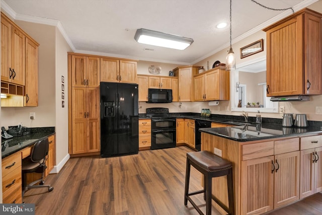 kitchen with a sink, dark wood-type flooring, black appliances, and crown molding