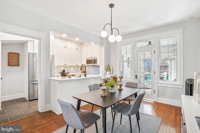 dining space featuring baseboards and dark wood-style floors