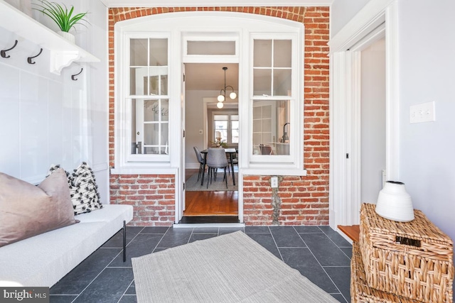 doorway to property featuring brick siding