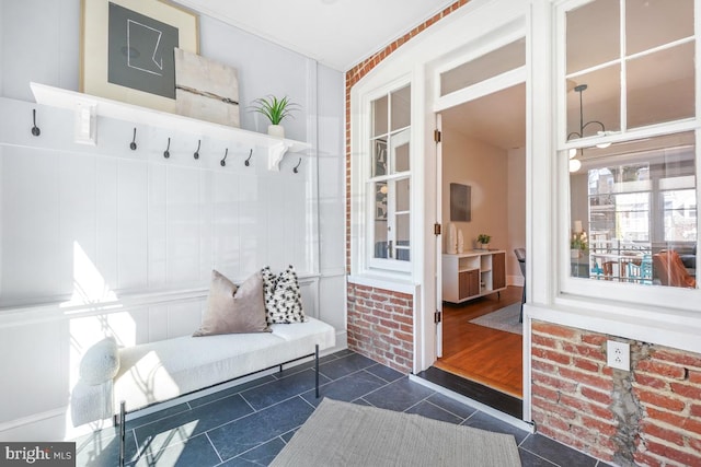 mudroom with dark tile patterned floors