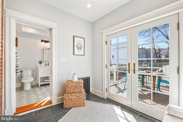 doorway featuring tile patterned floors, french doors, baseboards, and radiator