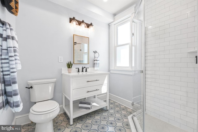 full bathroom featuring baseboards, vanity, toilet, and a shower stall