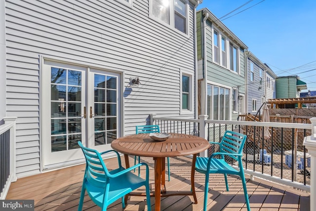 deck featuring french doors and fence