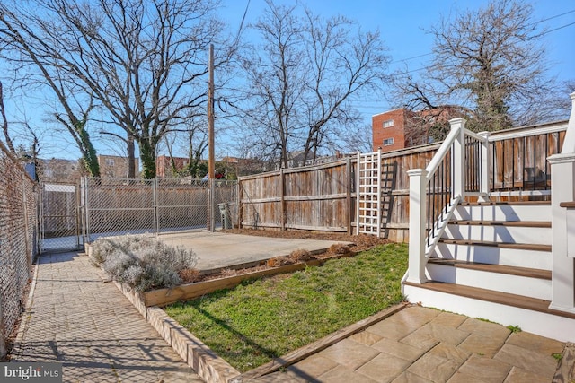 view of yard featuring stairs, a patio area, a gate, and fence