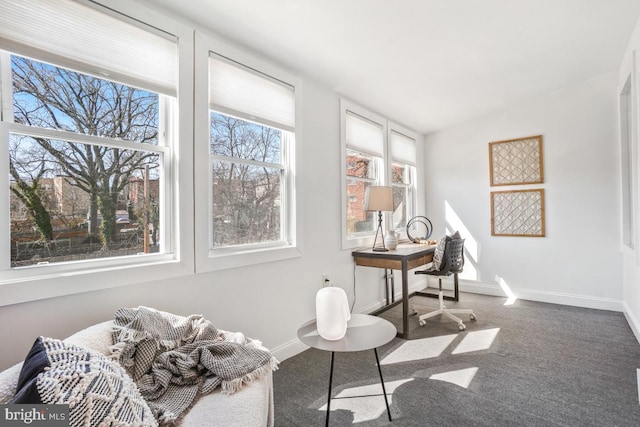 living area with carpet flooring, baseboards, and lofted ceiling