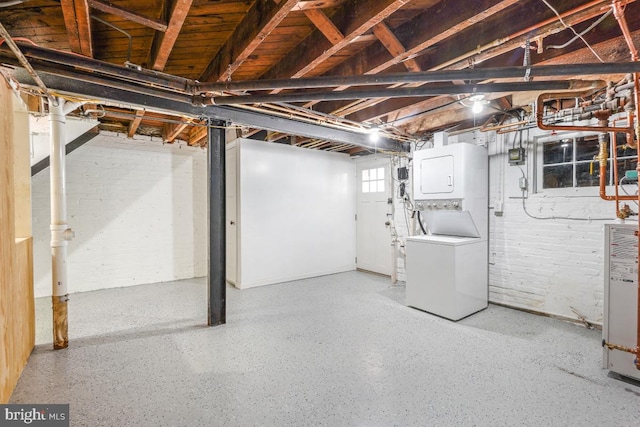 basement with stacked washer / dryer