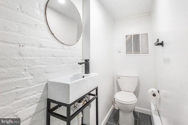 bathroom featuring tile patterned flooring, toilet, baseboards, and visible vents