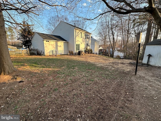 view of yard with an outdoor structure and fence