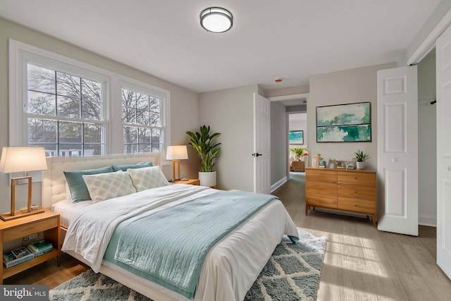 bedroom featuring baseboards and wood finished floors