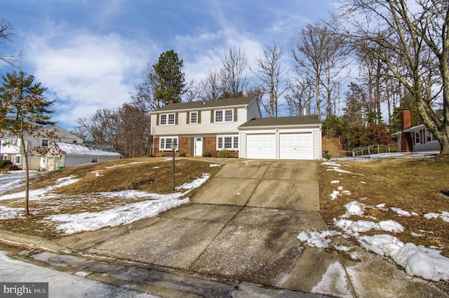 colonial house featuring brick siding, concrete driveway, and a garage