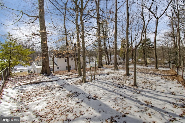 snowy yard with fence