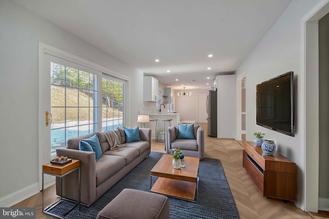 living area featuring recessed lighting and baseboards