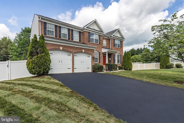 15200 Spotted Turtle Ct, Woodbridge, VA 22193 - view of property with brick siding, a garage, fence, and aphalt driveway