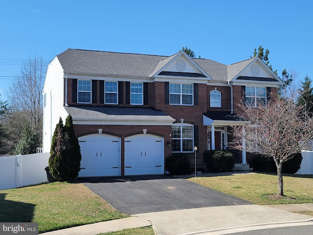 15200 Spotted Turtle Ct, Woodbridge, VA 22193 - view of property with fence, an attached garage, a front lawn, brick siding, and driveway