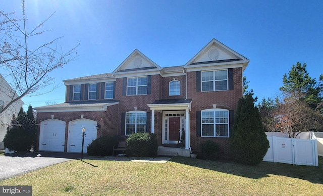 15200 Spotted Turtle Ct, Woodbridge, VA 22193 - view of front facade featuring brick siding, fence, driveway, and a front lawn