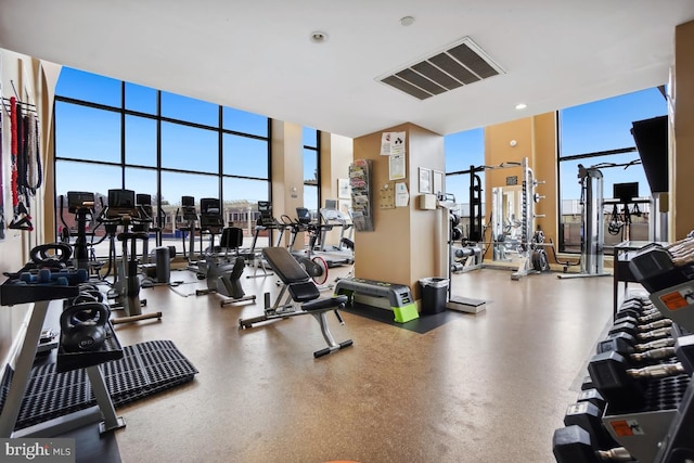 gym with a wall of windows and a wealth of natural light