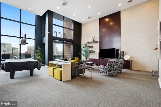 interior space with a city view, pool table, a high ceiling, and carpet floors