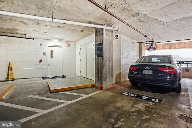 parking deck featuring concrete block wall