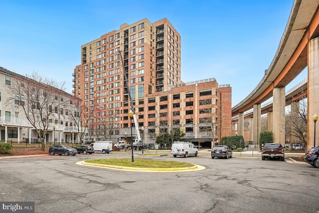 view of building exterior with uncovered parking