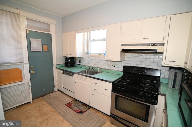 kitchen featuring radiator heating unit, a sink, under cabinet range hood, dishwasher, and stainless steel gas stove