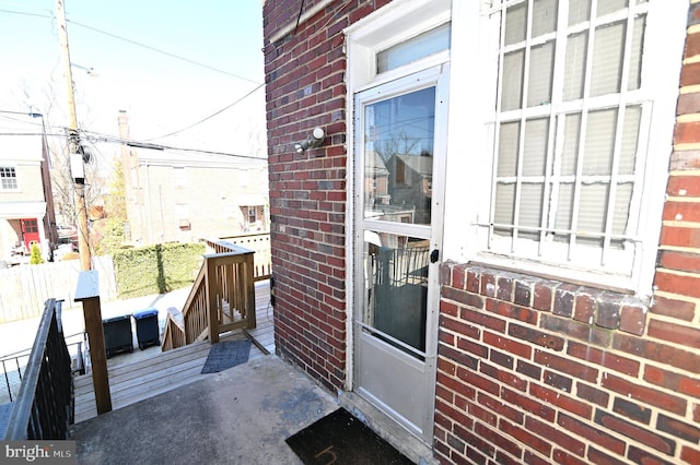 view of exterior entry with brick siding