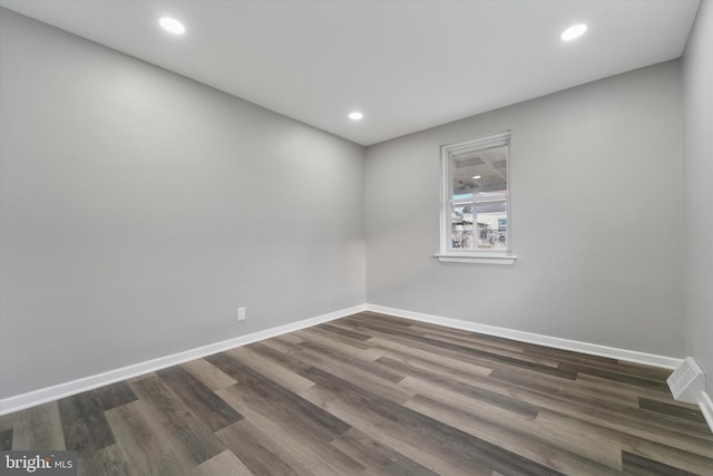 unfurnished room with recessed lighting, visible vents, baseboards, and dark wood-type flooring