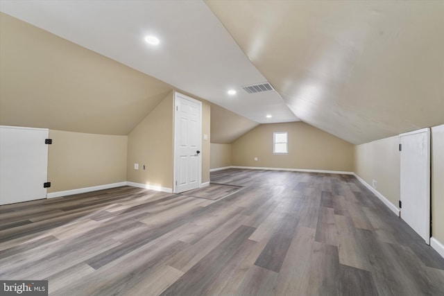 bonus room with visible vents, wood finished floors, recessed lighting, baseboards, and lofted ceiling