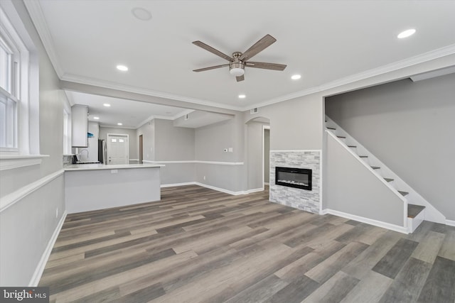 unfurnished living room with crown molding, recessed lighting, a ceiling fan, and dark wood-style flooring