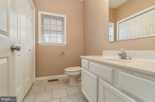 bathroom featuring visible vents, toilet, tile patterned flooring, baseboards, and vanity