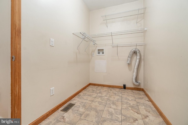 clothes washing area featuring visible vents, baseboards, washer hookup, and laundry area