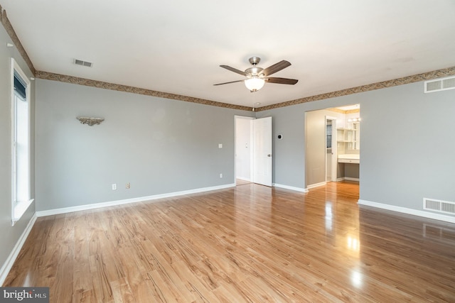 unfurnished room featuring visible vents, baseboards, light wood-type flooring, and ceiling fan