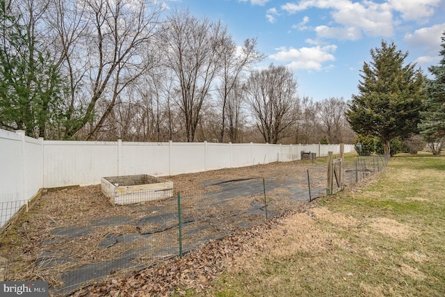 view of yard with a vegetable garden and fence