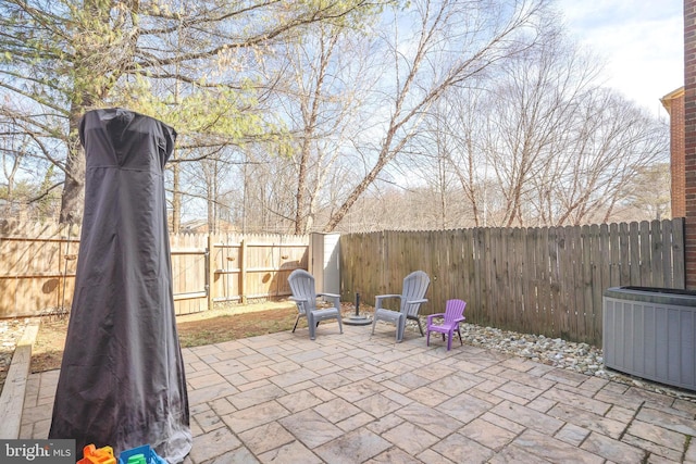 view of patio with cooling unit and a fenced backyard