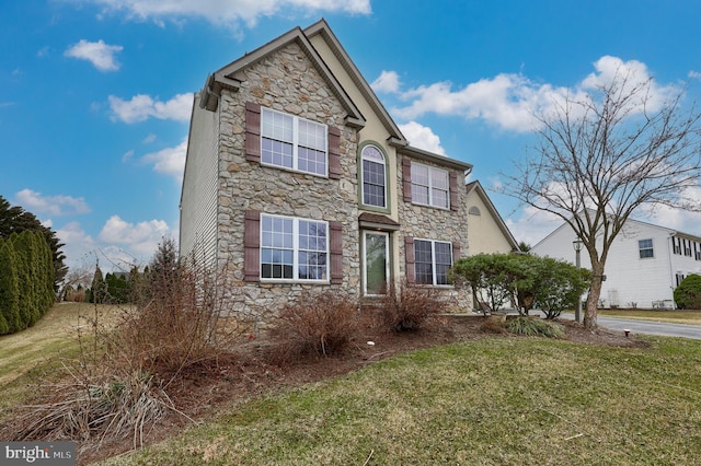 traditional-style home featuring stone siding and a front lawn