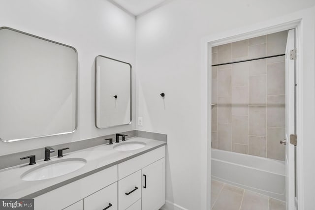 bathroom featuring double vanity, tile patterned flooring, shower / washtub combination, and a sink