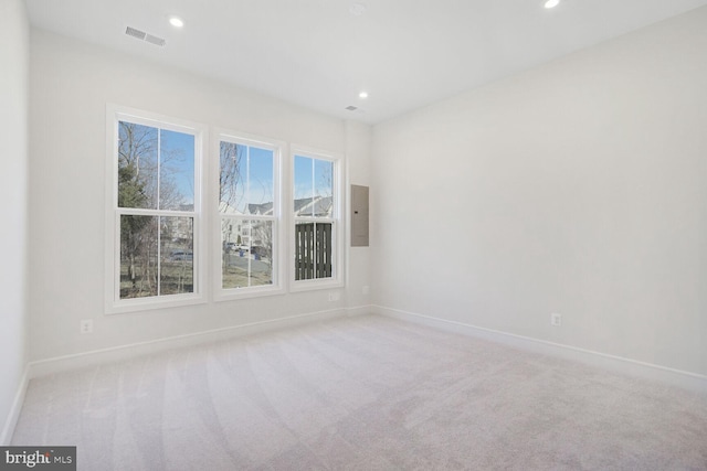 carpeted empty room with recessed lighting, visible vents, and baseboards