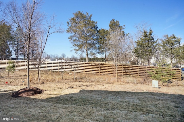 view of yard featuring a rural view and fence