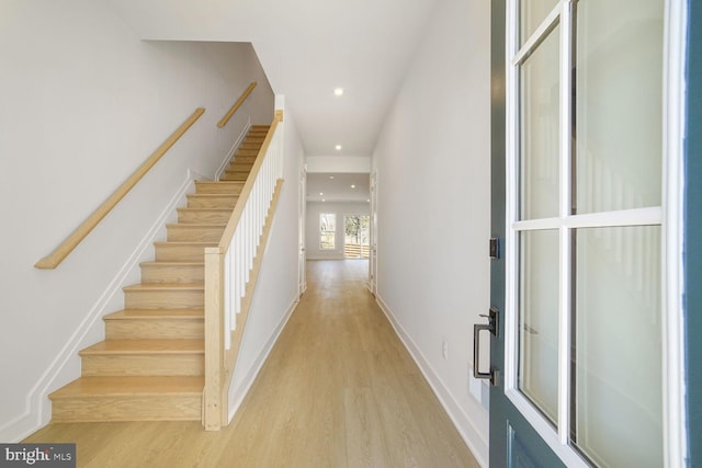 entrance foyer with recessed lighting, baseboards, stairs, and light wood-style floors